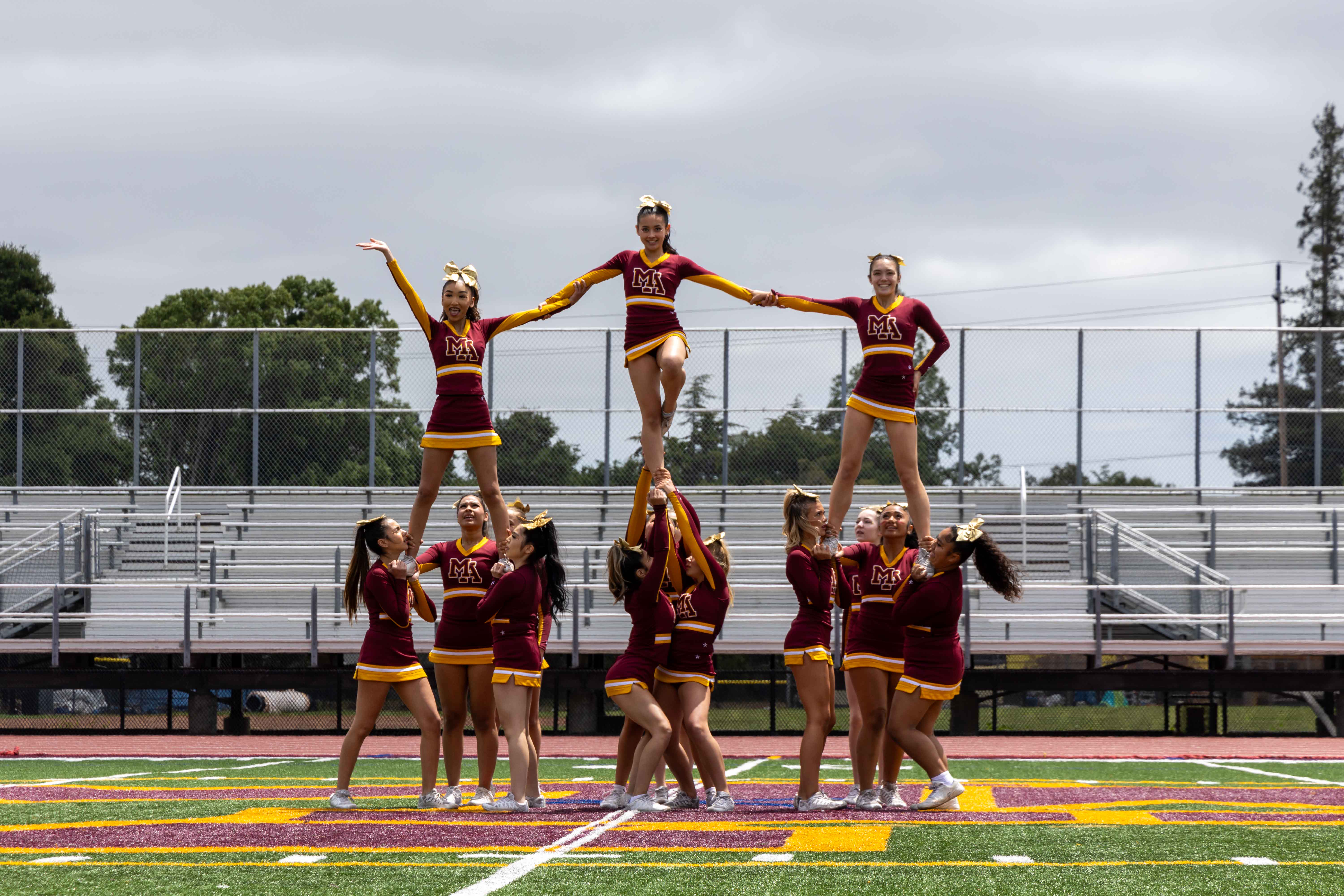 Cheerleaders energizes the crowd with electrifying choreography.