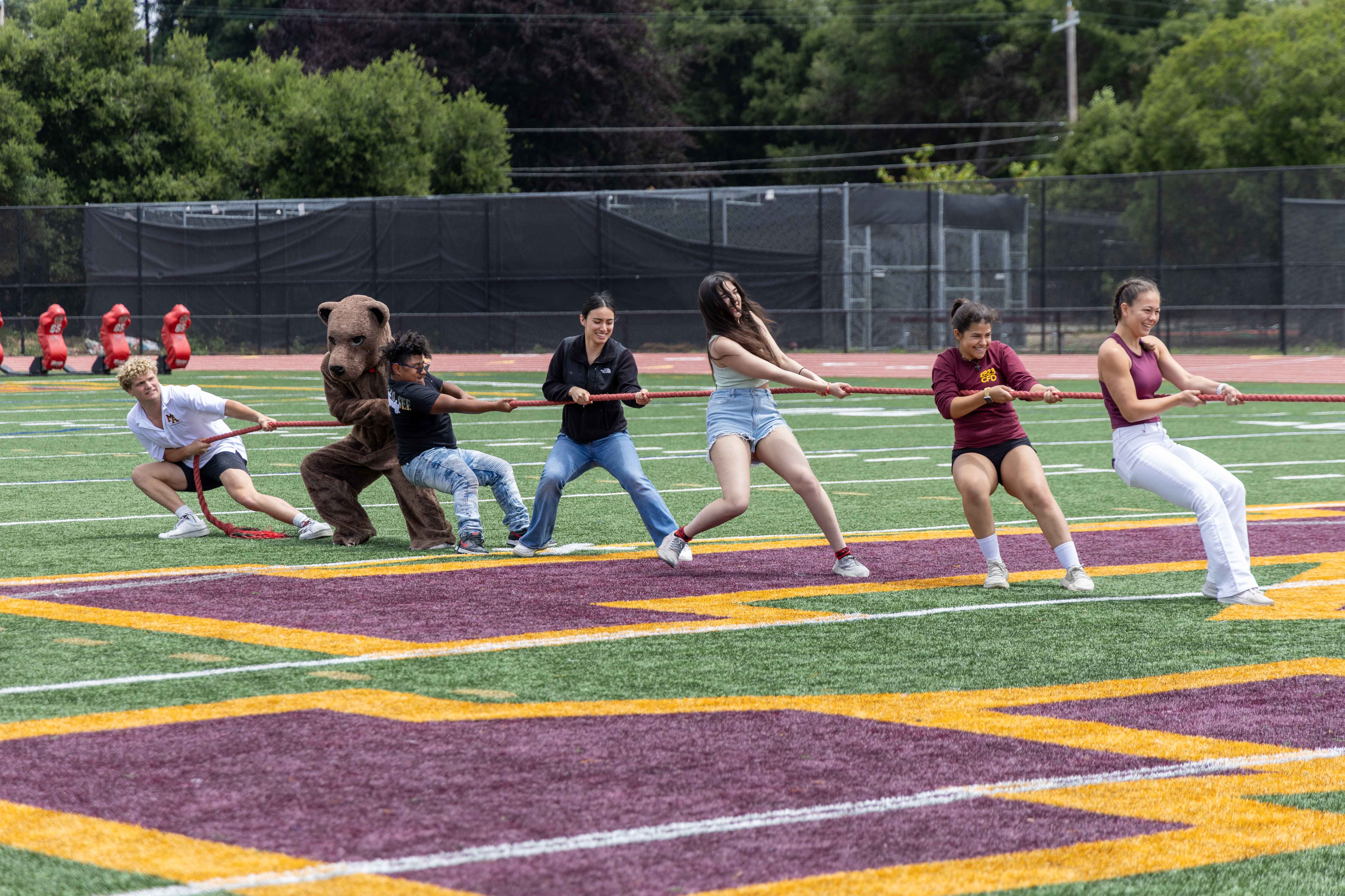 Students picked from the crowd compete in tug-of-war.