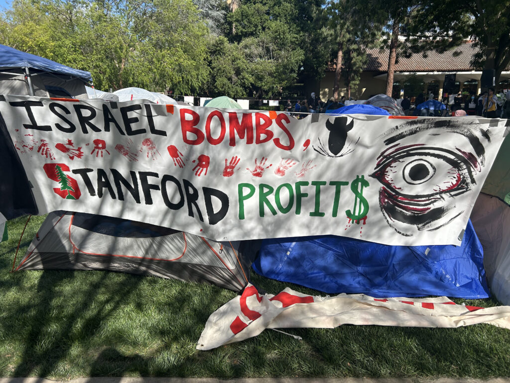 Protest sign by Stanford students that reads "Israel Bombs, Stanford Profits"