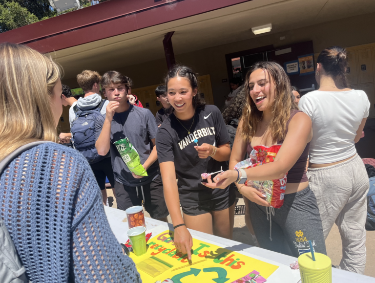APES students hand out candy with their trivia activity.