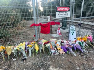 Flowers for Dylan near the train tracks where he passed away.