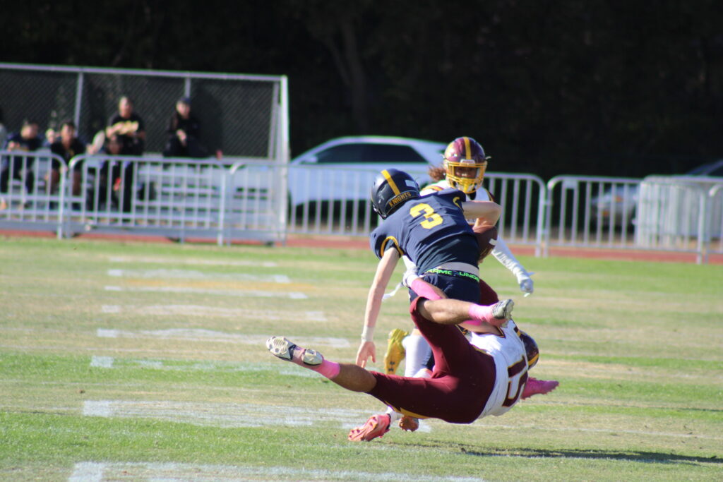 Senior linebacker Anthony van der Meer tackling a Menlo player.