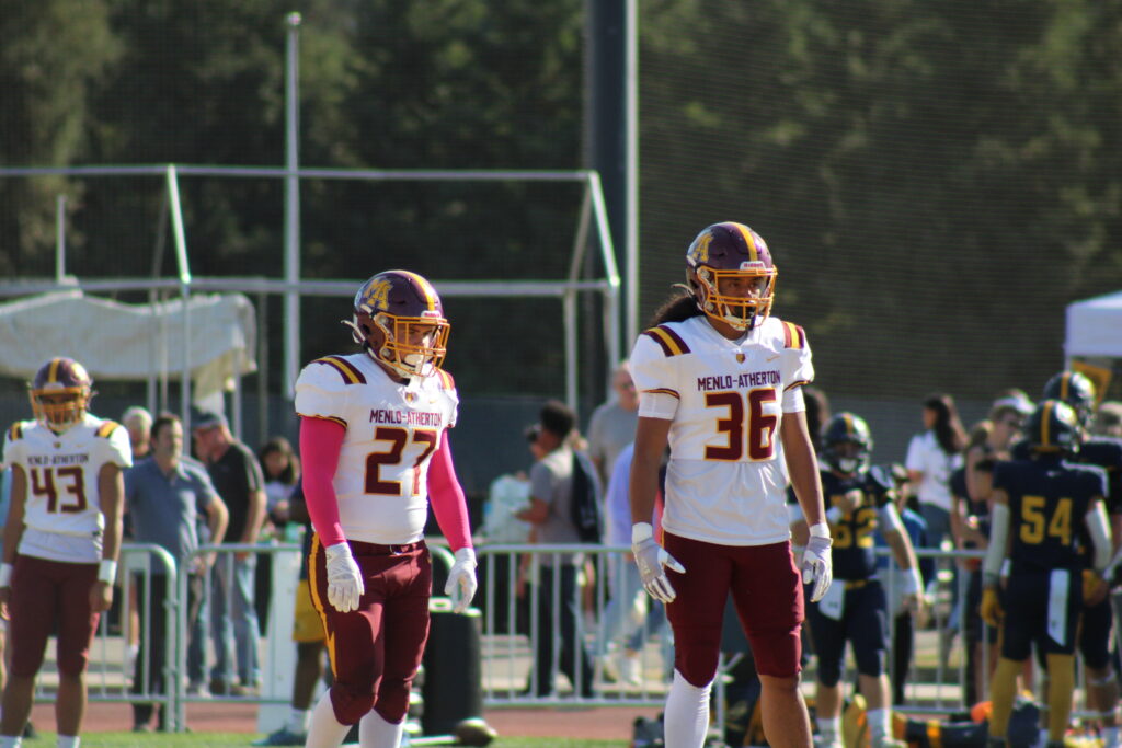 Senior linebackers Cole Cadieux (left) and Semisi Tuipulotu (right) on the field prior to kickoff.