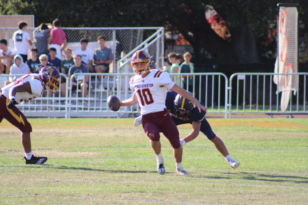 Junior quarterback Teddy Dacey running the ball.