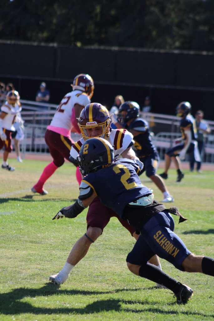 Senior wide receiver Josh Olsen blocking a defender.