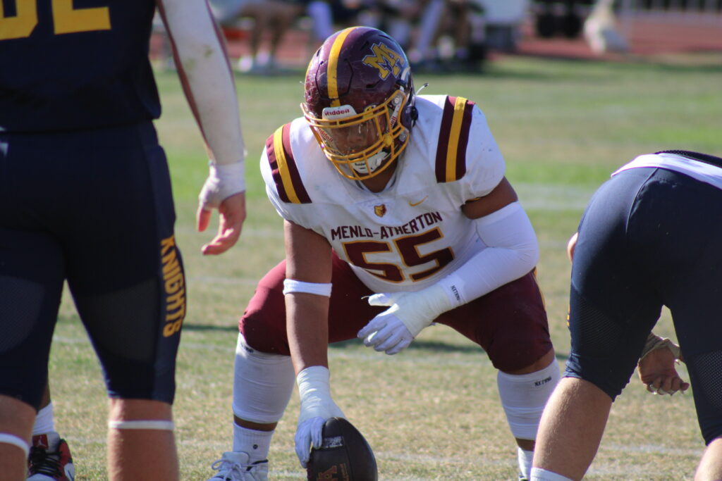 Junior center Jordan Lavulo snapping the ball.