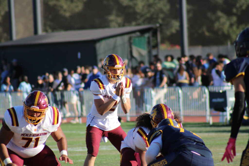 Senior quarterback Xander Eschelman hiking the ball.